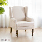 Sillón decorativo con patas torneadas y brazos redondos