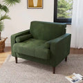 Sillón moderno tapizado de pana con brazos y cojines