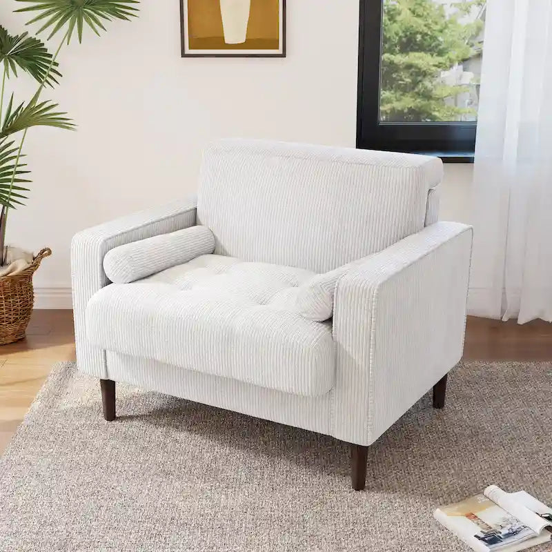 Sillón moderno tapizado de pana con brazos y cojines