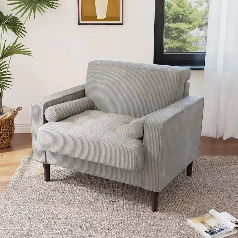 Sillón moderno tapizado de pana con brazos y cojines