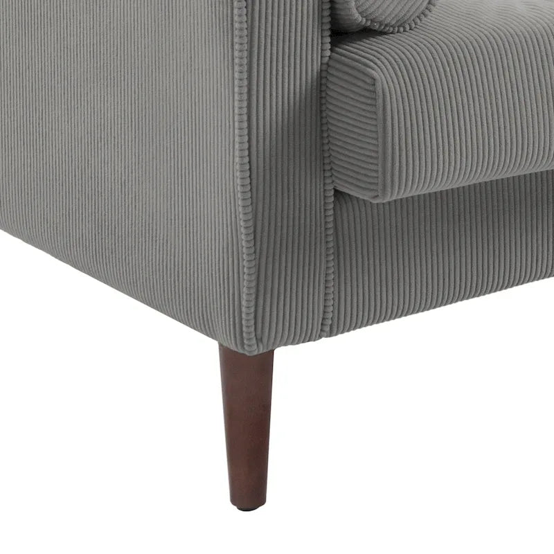 Sillón moderno tapizado de pana con brazos y cojines
